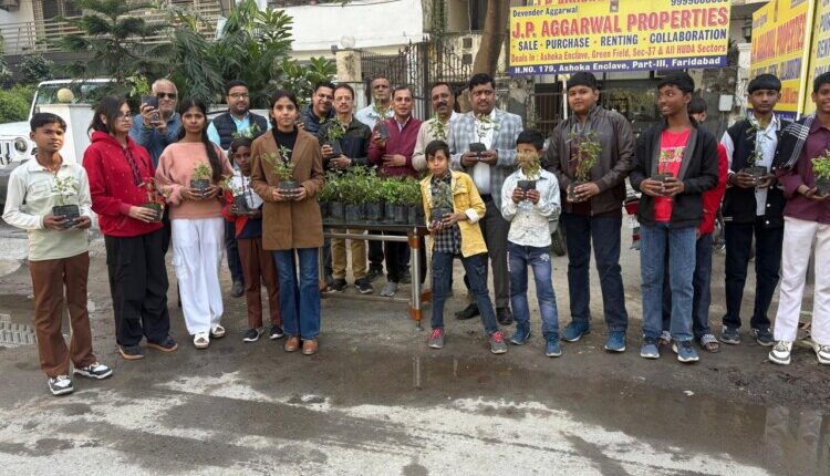 Tulsi plants were distributed to passersby on Tulsi Puja Day.