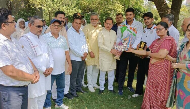 Athletes sought blessings from Minister Rajesh Nagar after winning medals.